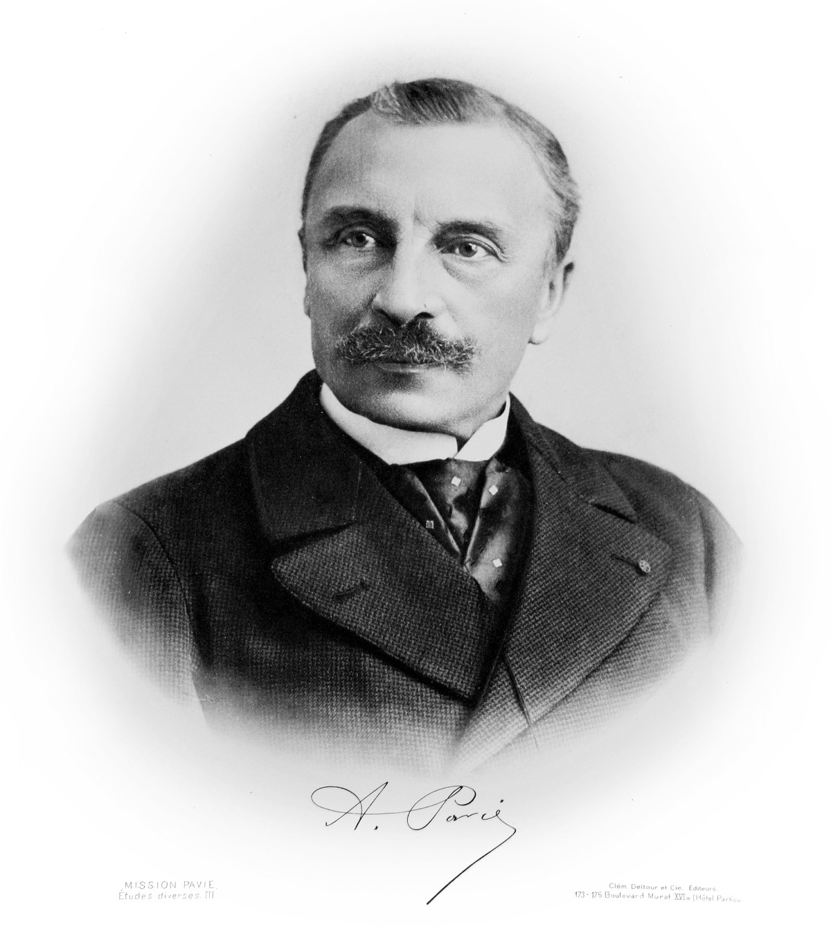 A photographic portrait of a bearded Frenchman in a dark coat