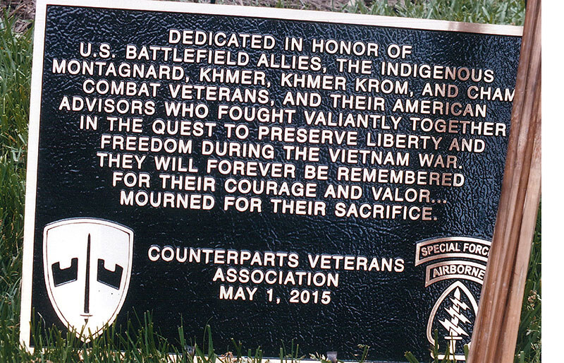 A bronze plaque dedicated to the Montagnard, Khmer, Khmer Krom and Cham combat veterans and their American advisors, with the emblems of the Special Forces
