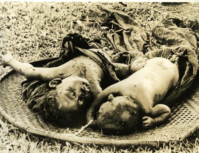 Two dead small children lying together in a round woven tray