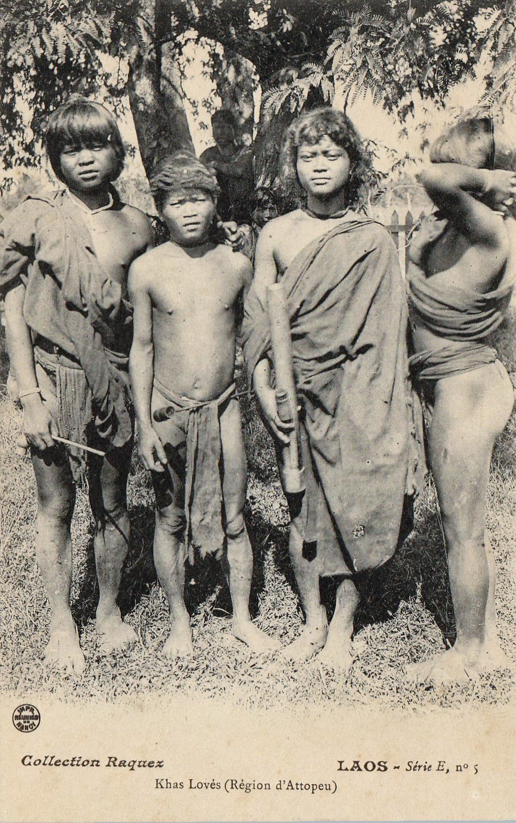 An old postcard of highland men standing in a row under trees