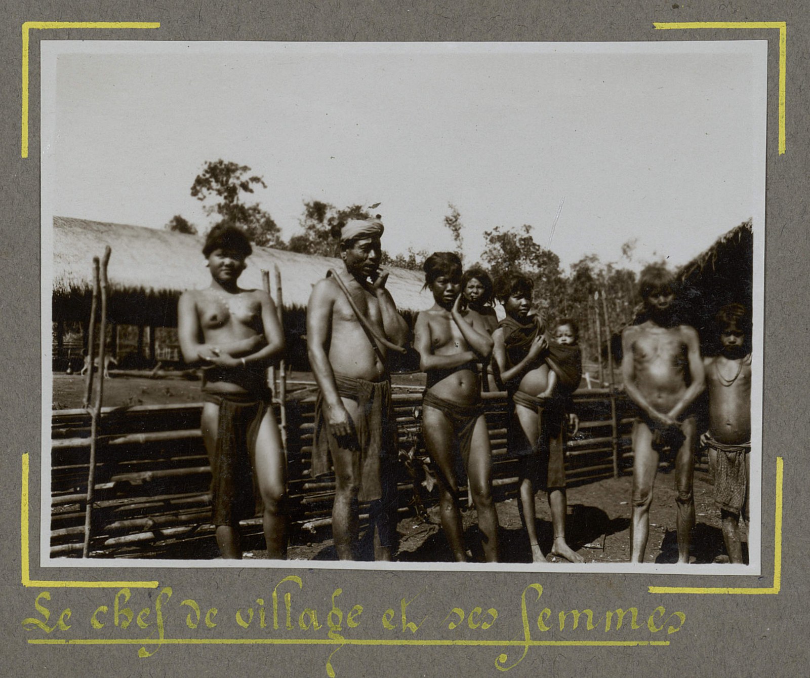 A highland chief standing with several women in front of a house