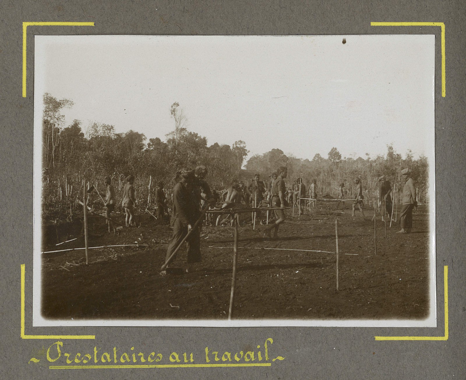 A group of highland men working with tools on open ground