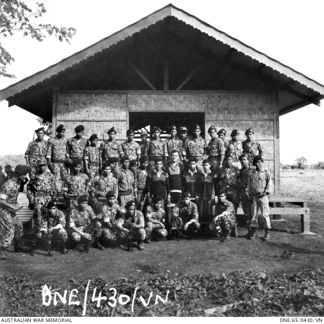 An Australian officer standing with a group of highland fighters