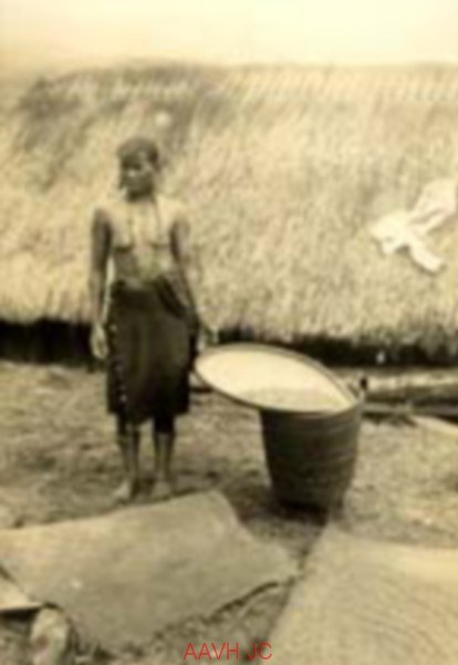 A highland woman winnowing rice in a flat basket