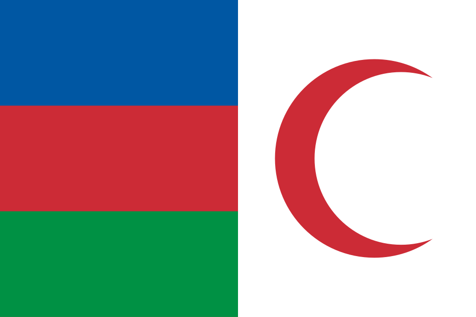 A flag with a blue and red panel at the hoist and a large red crescent on white