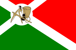 A flag divided diagonally, green below and red above, with a white diagonal band and an emblem in a white disc