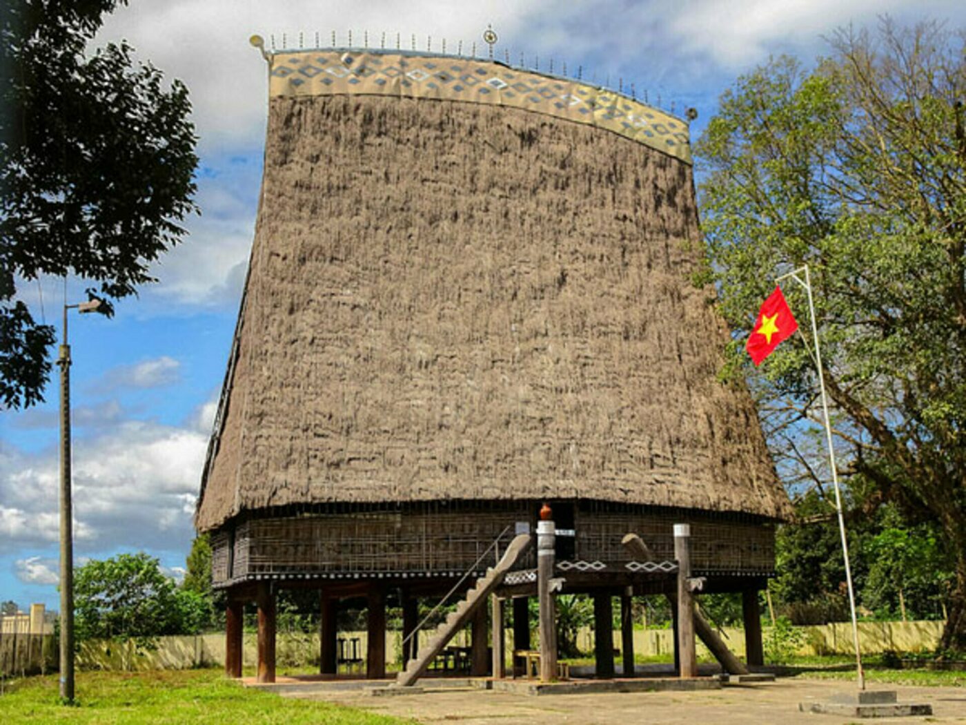 The tall thatched rong house at Kon Klor with its steep roof rising above the village