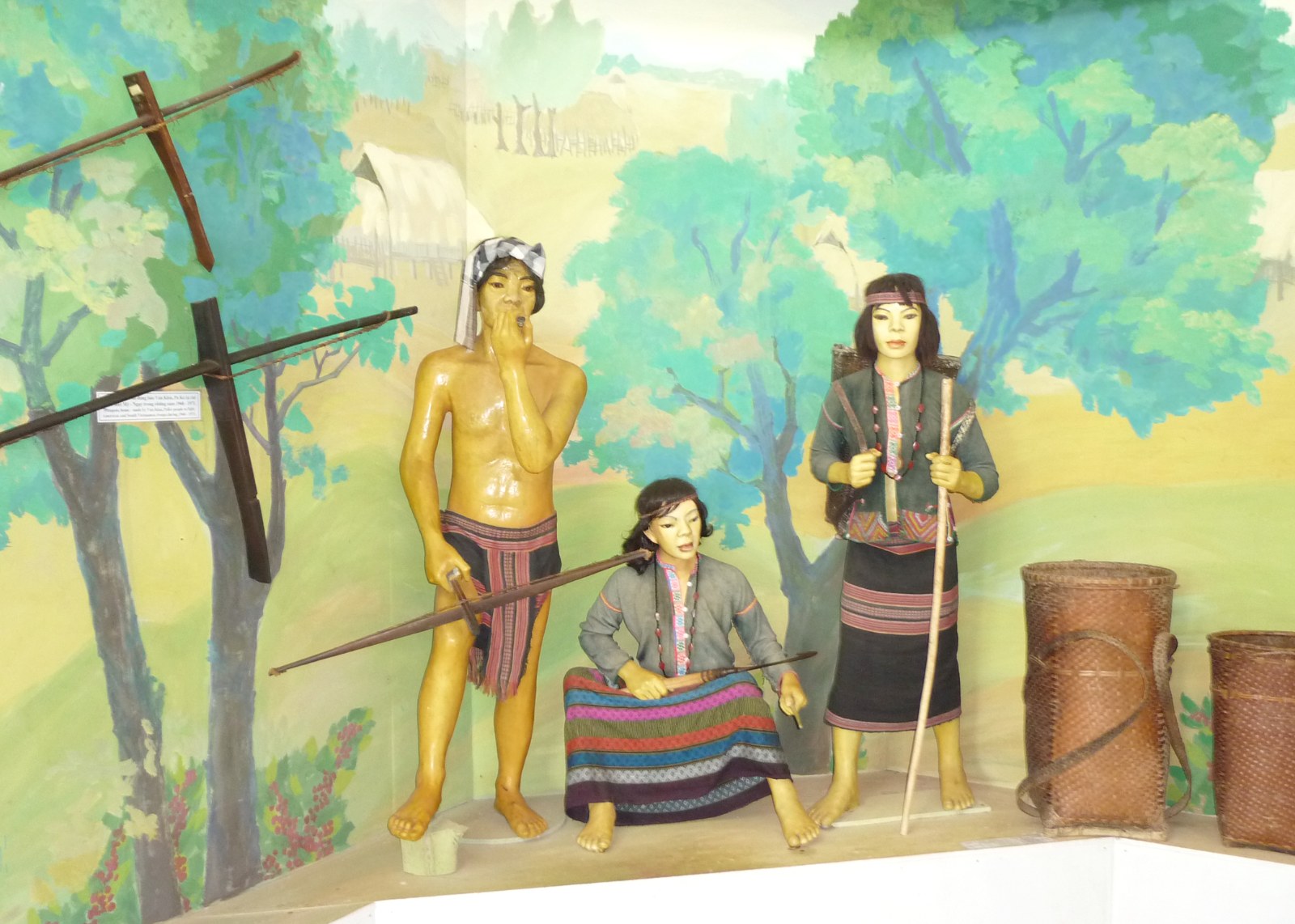 A painted museum diorama with figures of Bru people in traditional dress