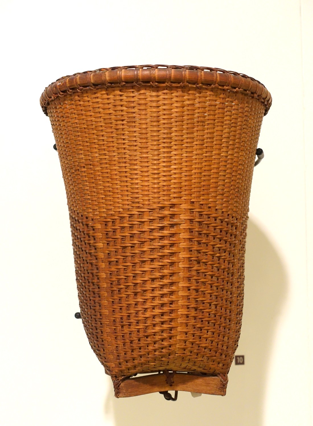 A woven carrying basket with straps