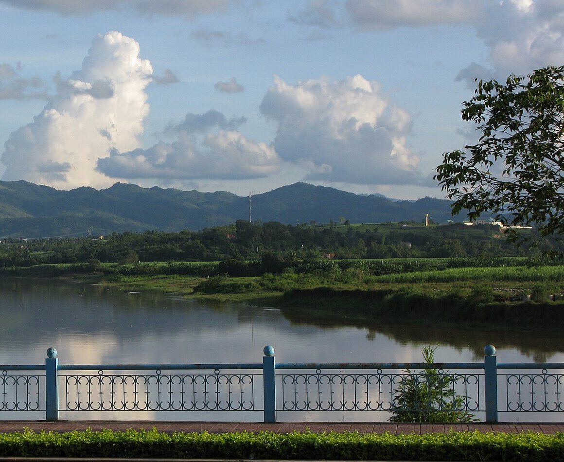 The Dak Bla river at Kon Tum, with green hills behind it