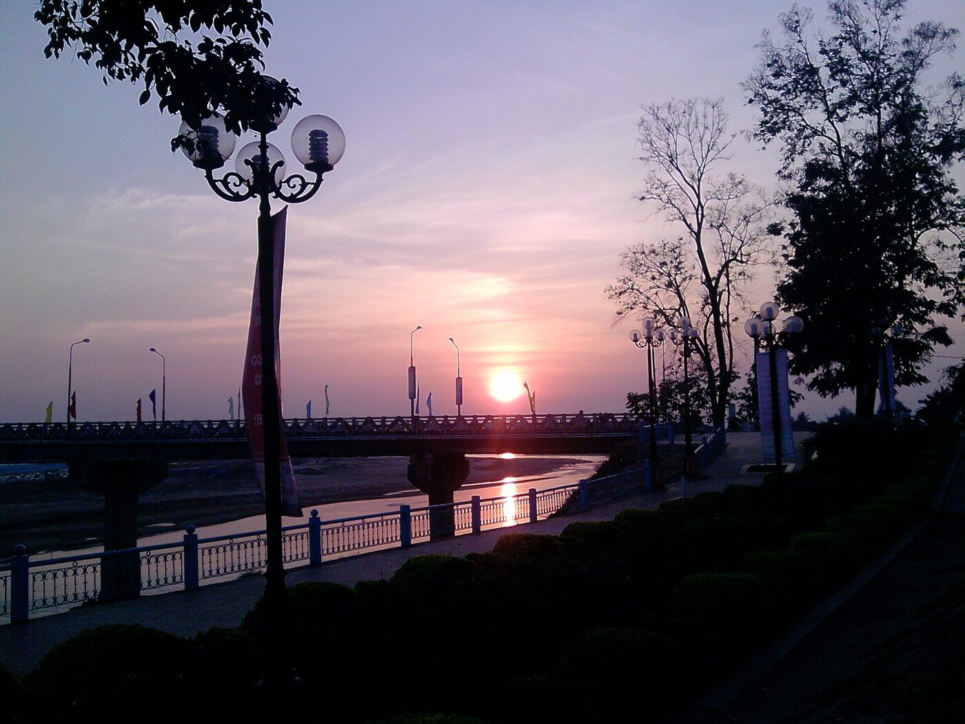 Sunset over the Dak Bla and its bridge at Kon Tum