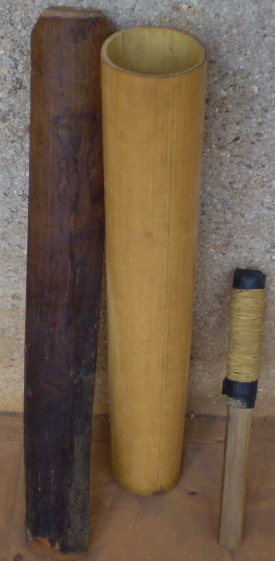 A set of bamboo tubes of graded lengths bound together upright, the Rhade bamboo gongs
