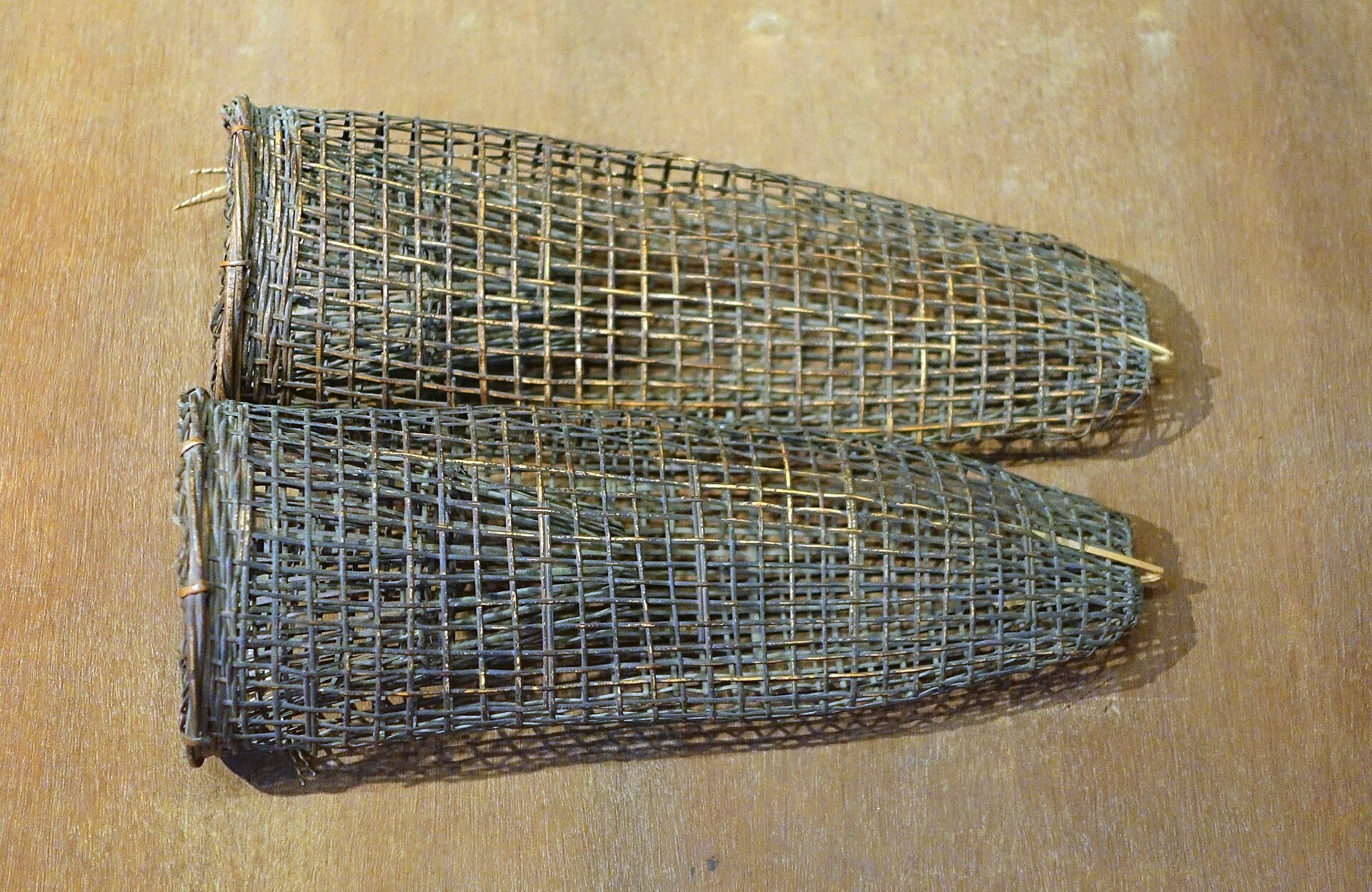 A long woven bamboo fish trap