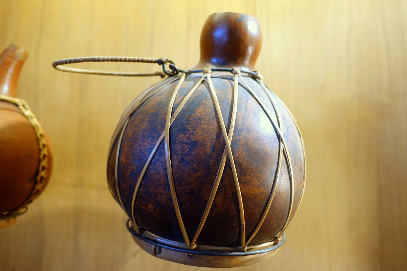 A gourd water container bound in rattan