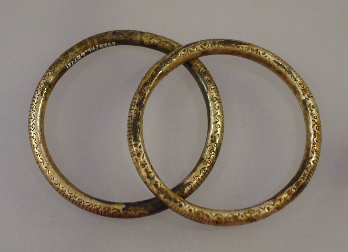 Two heavy silver bracelets with engraved patterns