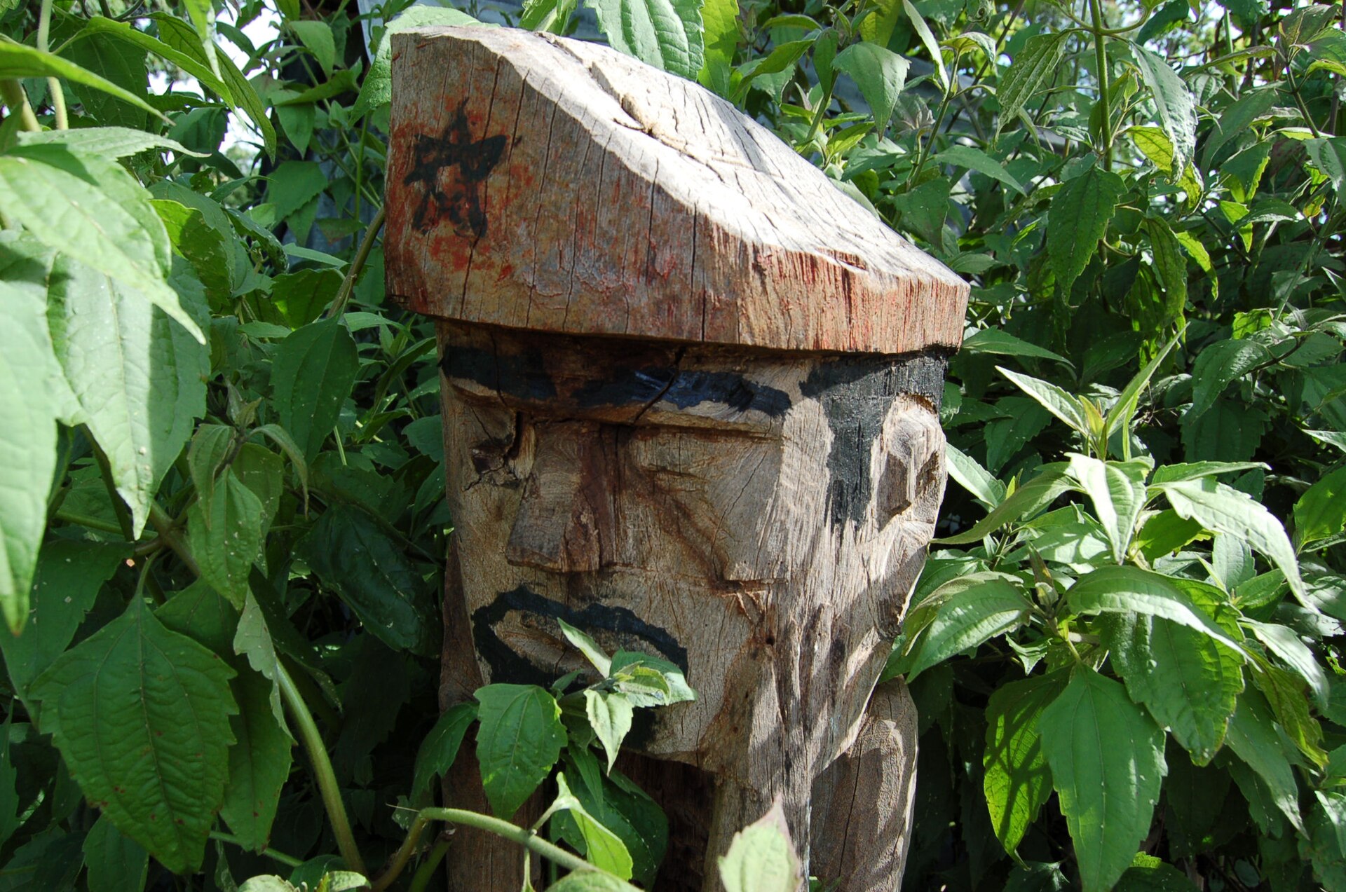 A carved wooden guardian figure on a Jarai tomb
