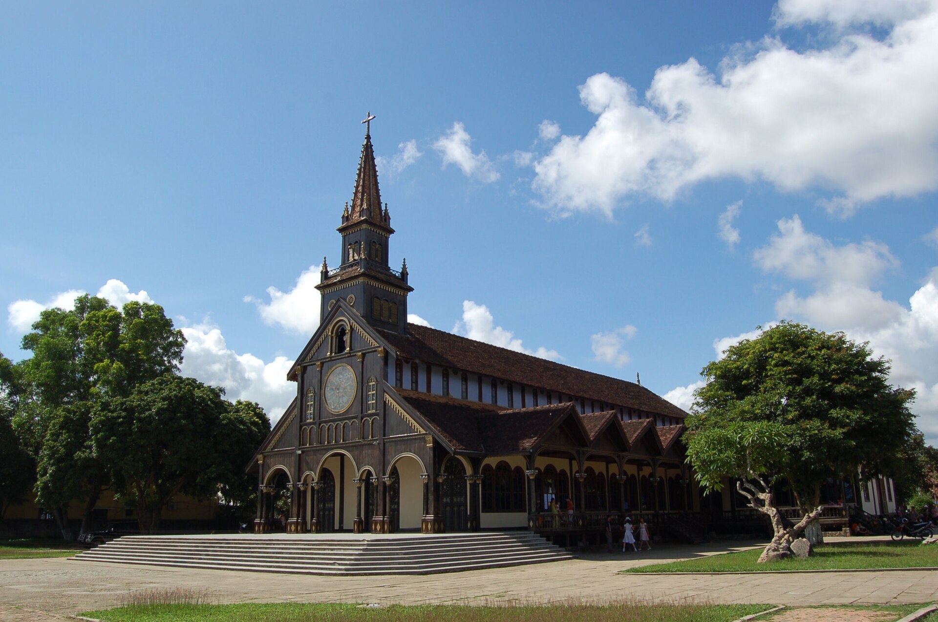 A dark wooden church with a tall spire