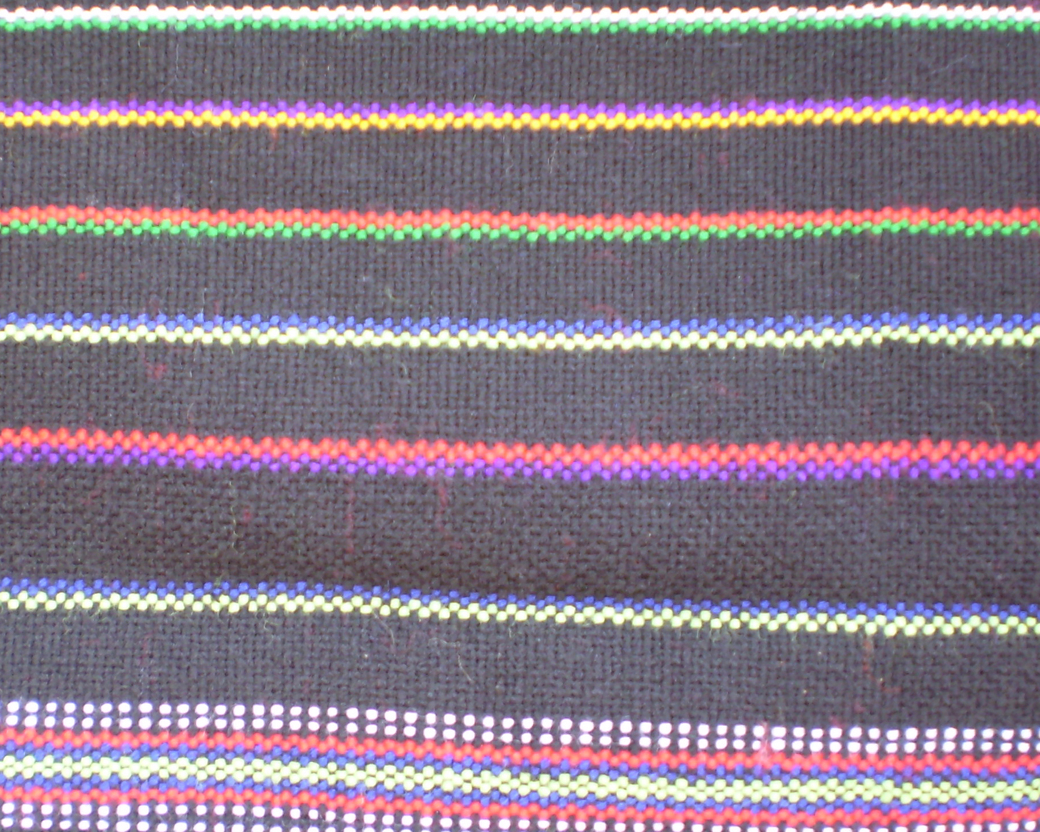 A length of dark handwoven cloth with bands of red, yellow, green and white