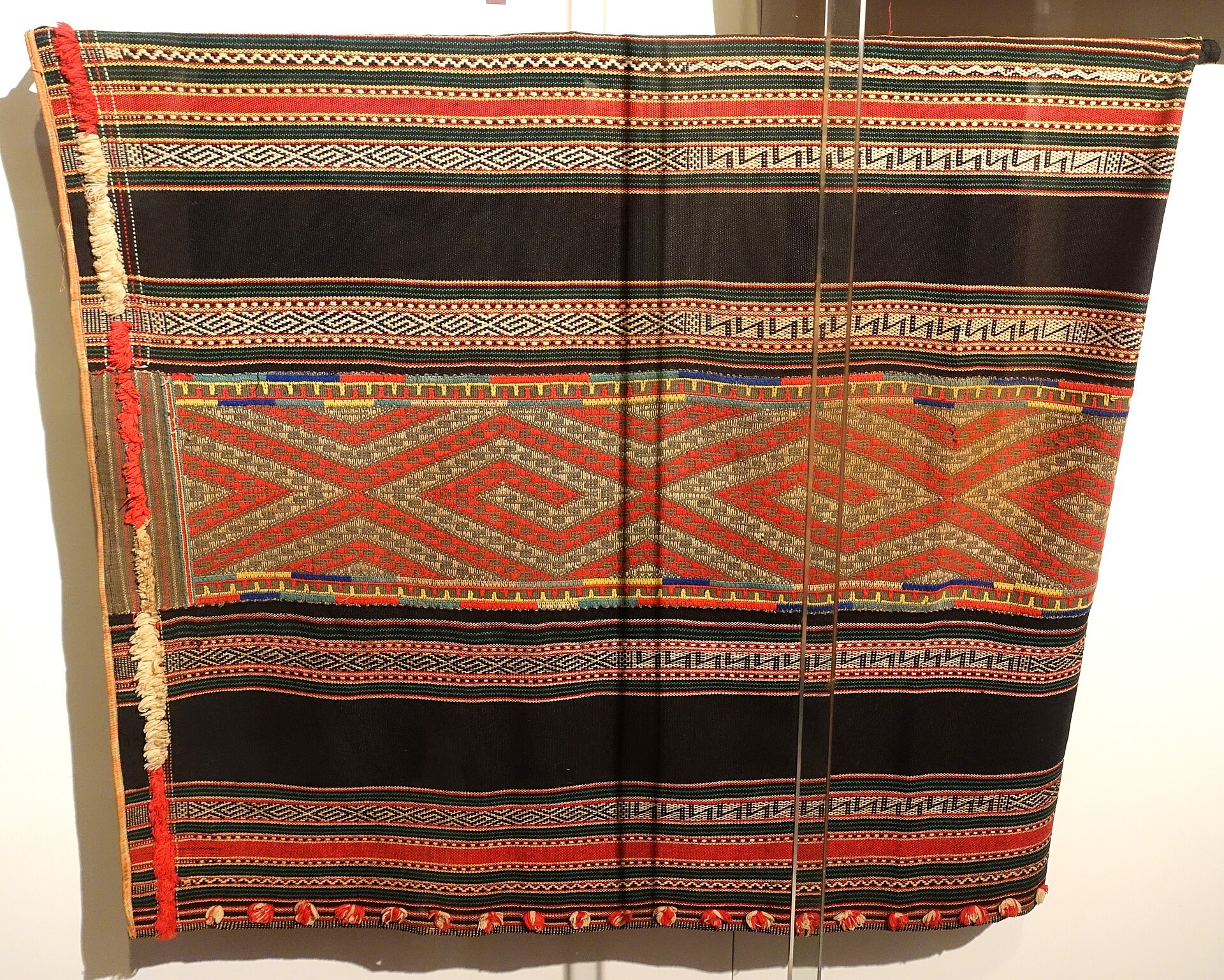 A dark handwoven skirt with narrow patterned bands