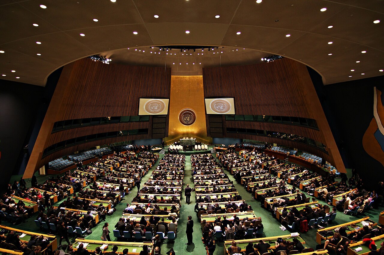 The General Assembly Hall of the United Nations in New York, with its gold wall and tiers of delegates’ desks